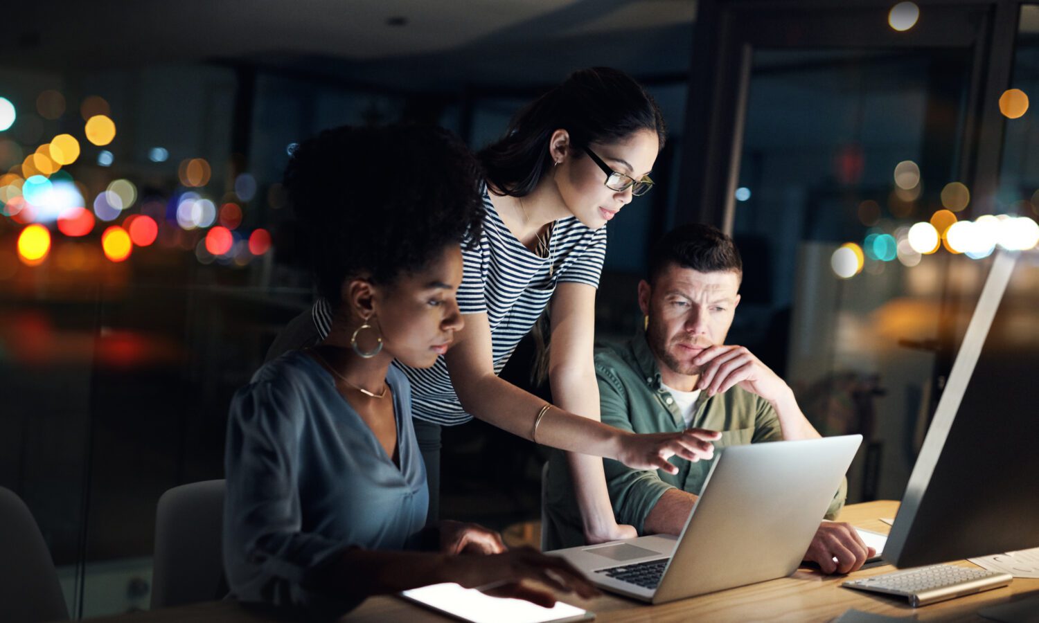 Shot of a group working late on a laptop in an office